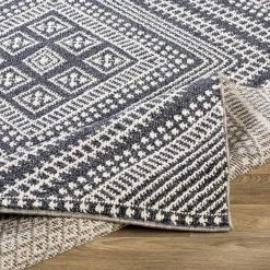 SURYA RADKA INDOOR-OUTDOOR RUG: CHARCOAL + WHITE